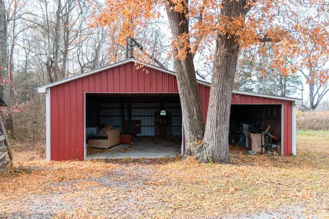 a view of a house with a yard and tree