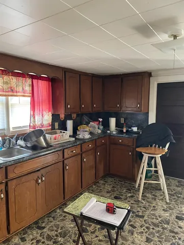 a kitchen with a sink stove and wooden cabinets