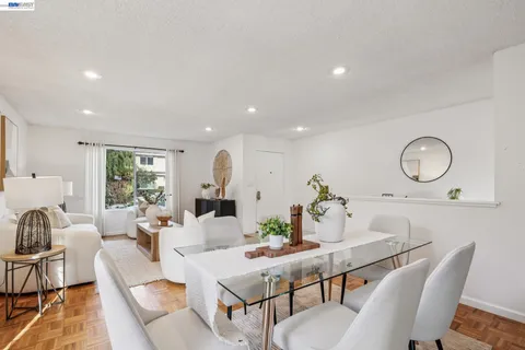 a kitchen with granite countertop a sink a counter top space and living room area