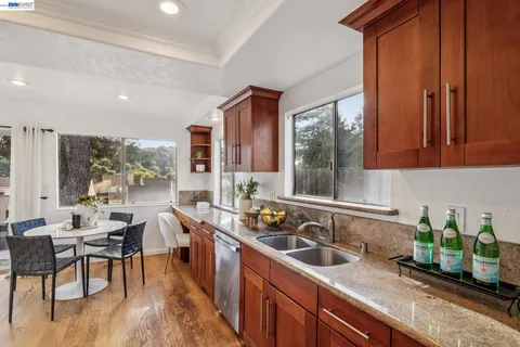a kitchen with a sink stove and cabinets