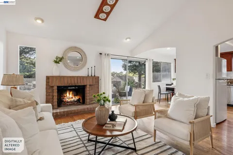 a living room with furniture a lamp a rug and a window