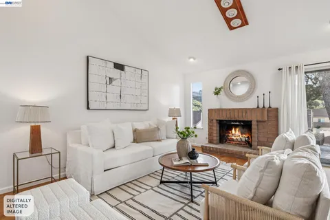 a living room with furniture and a dining table with wooden floor