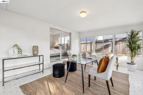 a bedroom with a bed and a painting on the wall