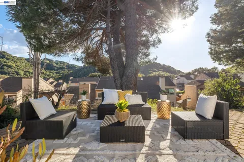a aerial view of a house with a yard and large trees