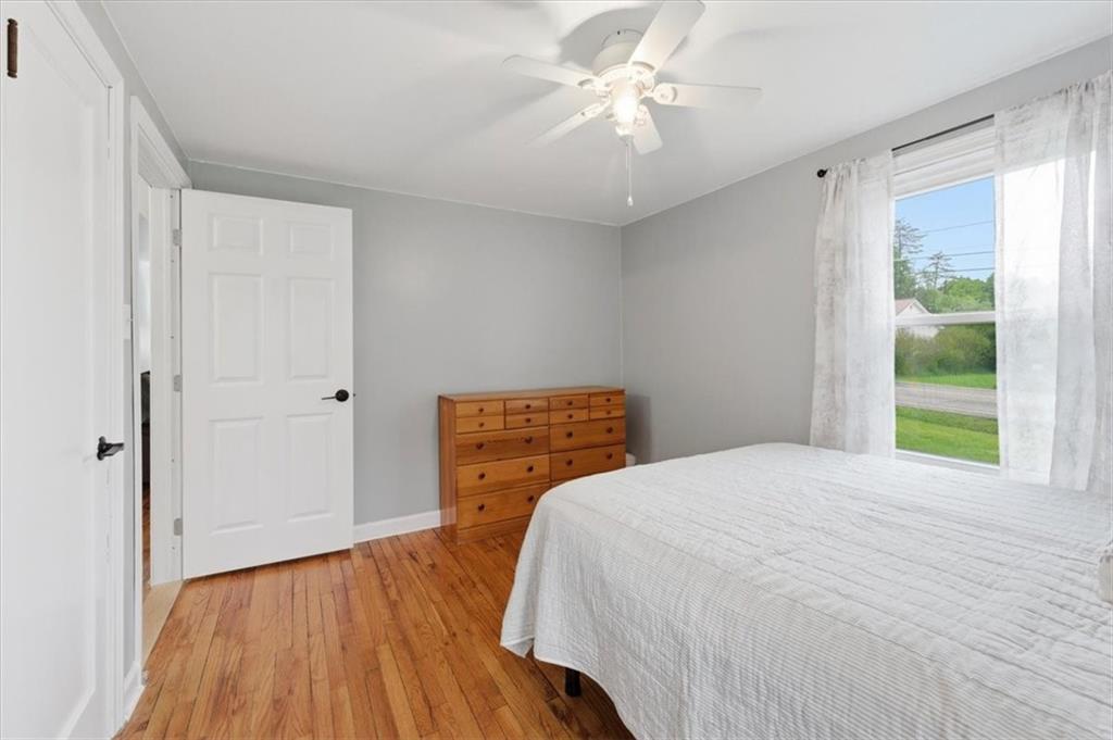 344 Winfield Road Cabot, PA 16023 - Photo 14 of 30 a bedroom with a bed and a wooden floor