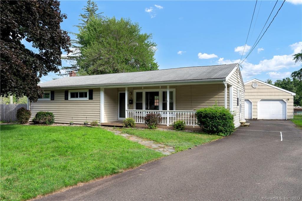 a front view of a house with a yard and porch