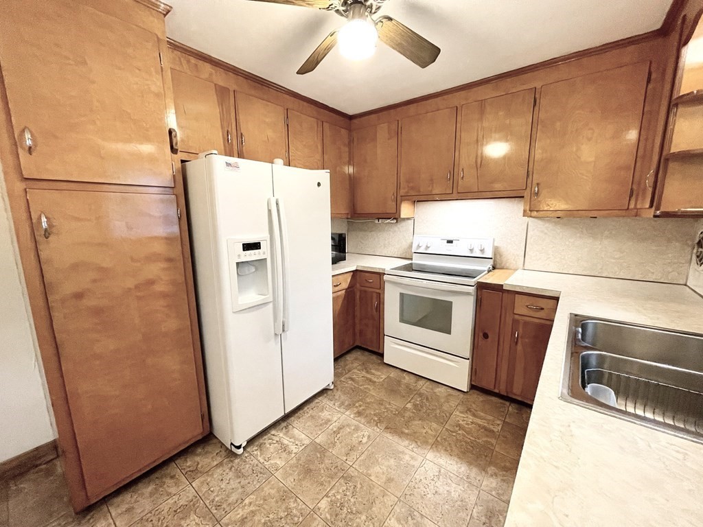 112 Ellendale Circle Springfield, MA 01128 - Photo 8 of 22 a kitchen with a refrigerator sink and cabinets