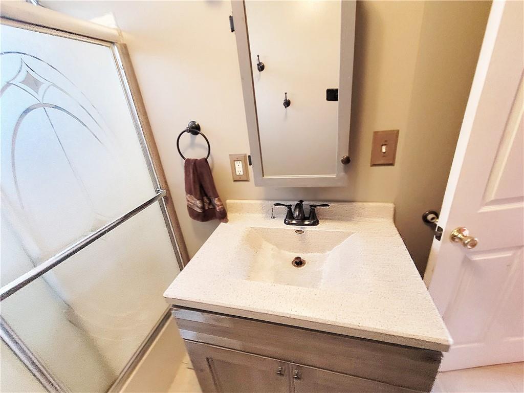 2340 Mercer West Middlesex Road West Middlesex, PA 16159 - Photo 29 of 36 a bathroom with a sink a toilet and a mirror