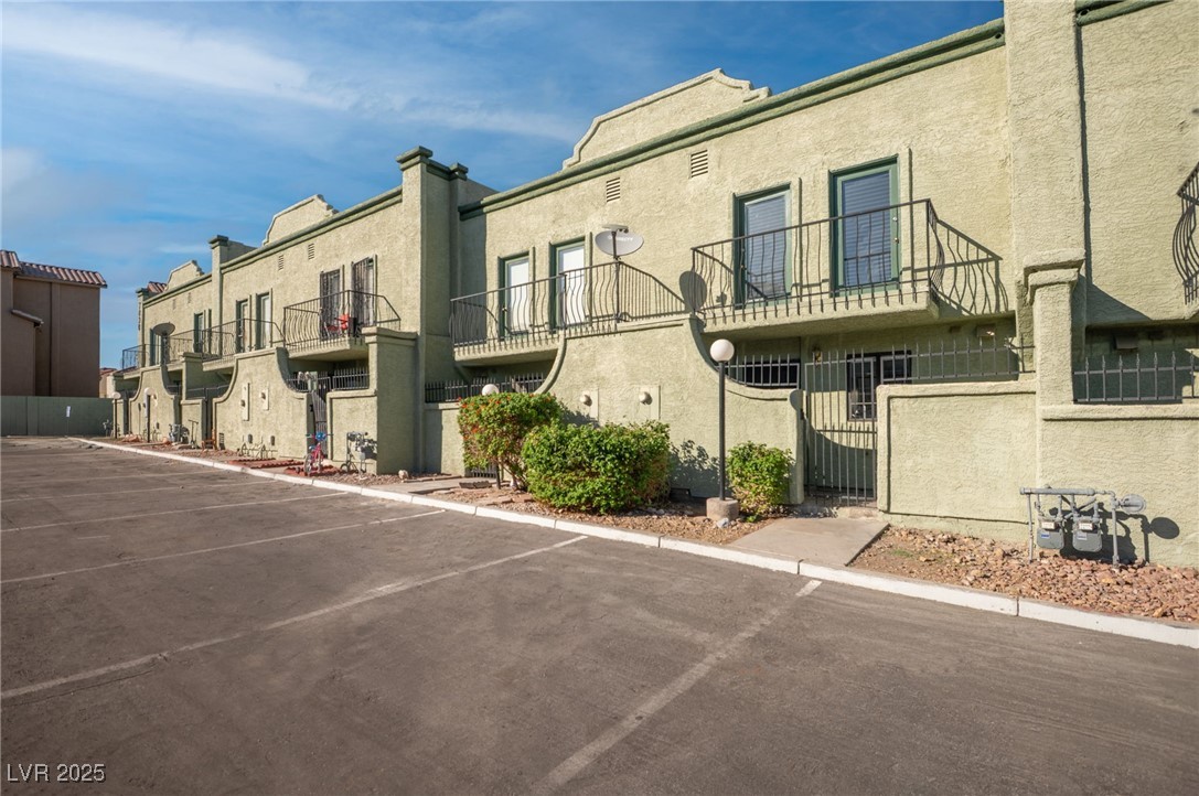 7030 Burcot Avenue, Unit F108 Las Vegas, NV 89156 - Photo 1 of 18 View of property featuring uncovered parking