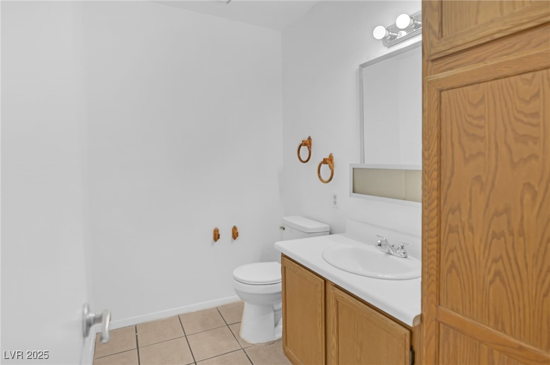 7030 Burcot Avenue, Unit F108 Las Vegas, NV 89156 - Photo 8 of 18 Bathroom featuring light tile patterned flooring and vanity