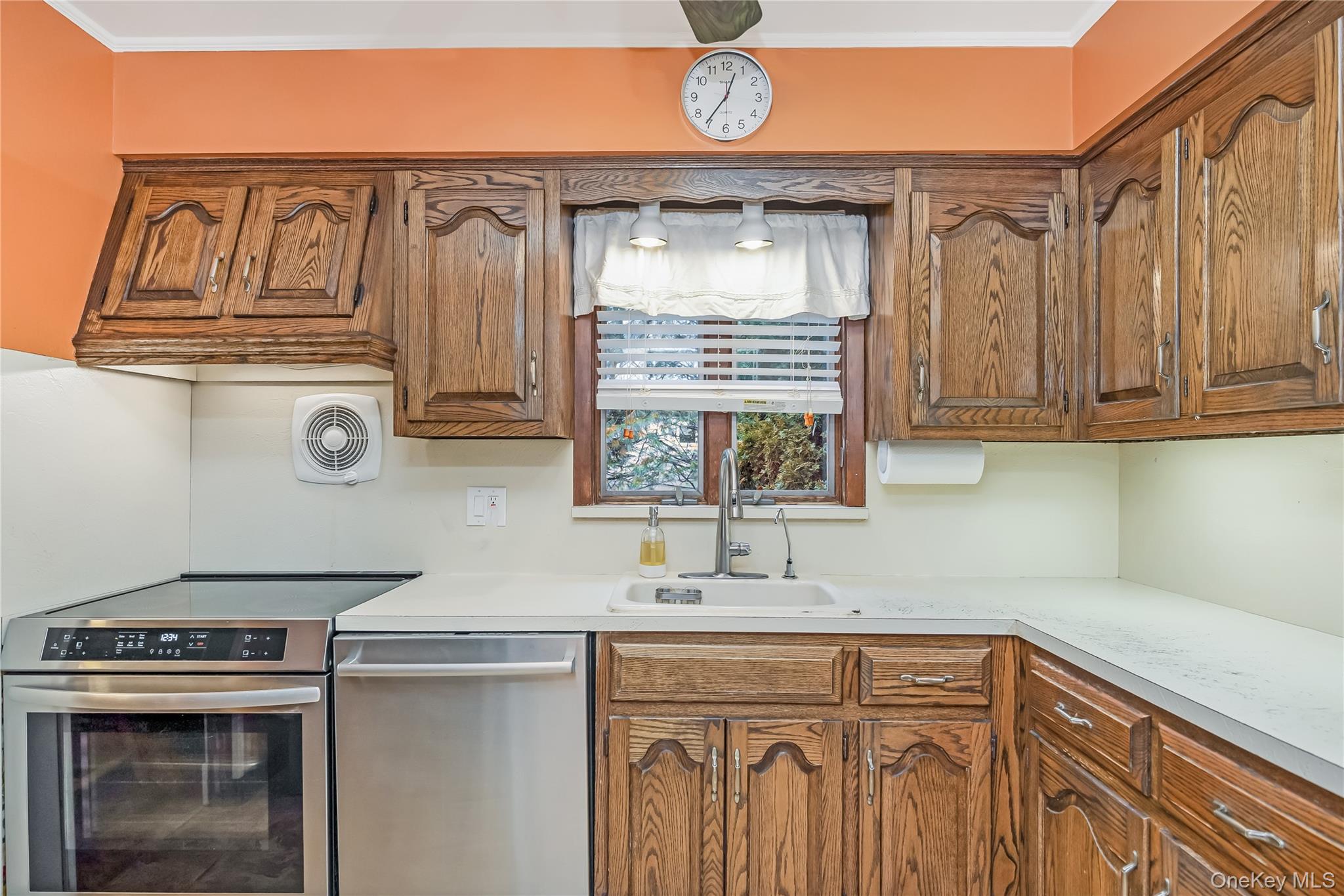 10 Roxbury Street Farmingdale, NY 11735 - Photo 12 of 25 a kitchen with stainless steel appliances granite countertop a sink a stove and cabinets