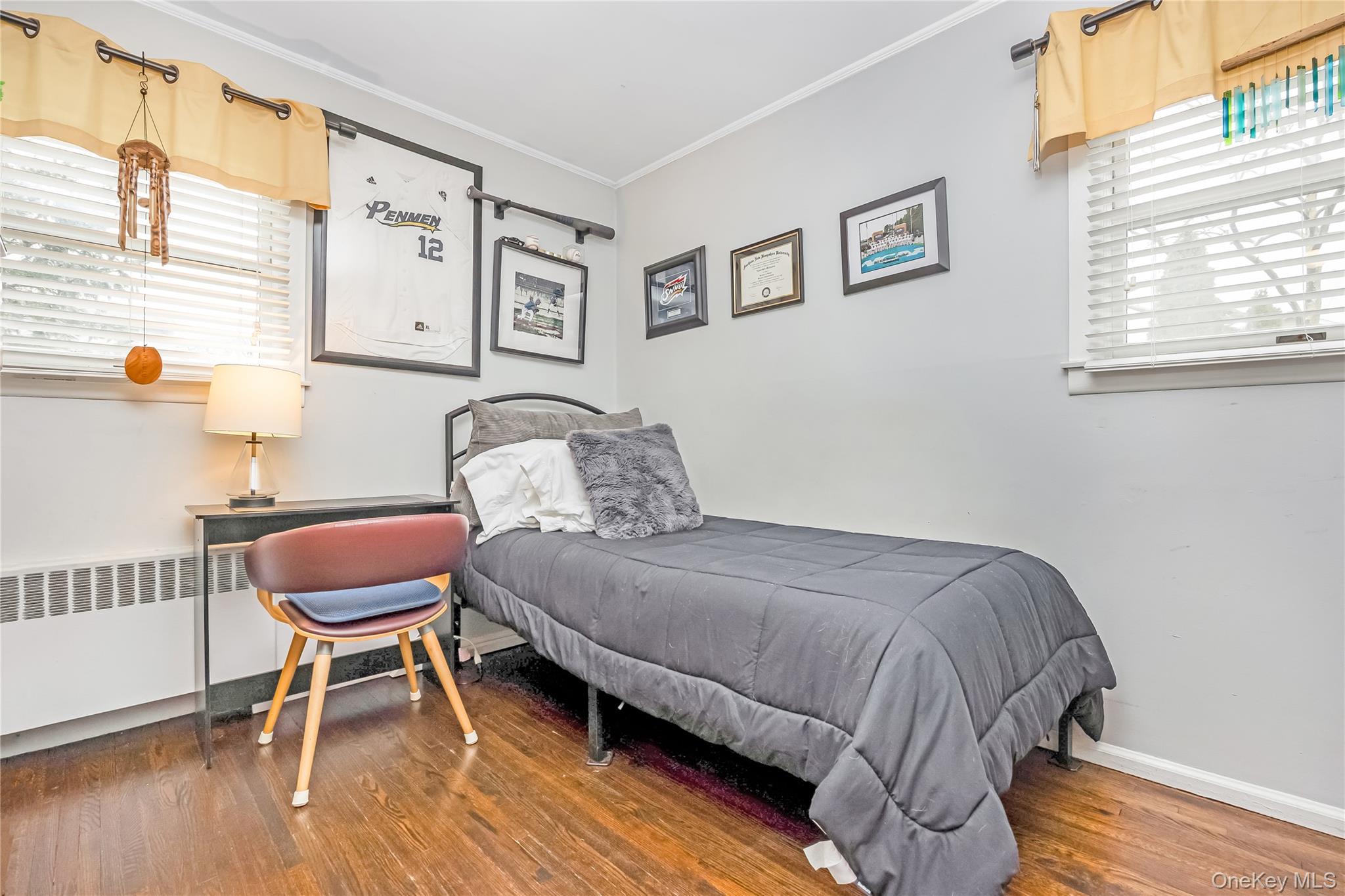 10 Roxbury Street Farmingdale, NY 11735 - Photo 14 of 25 a bedroom with a bed and a chair