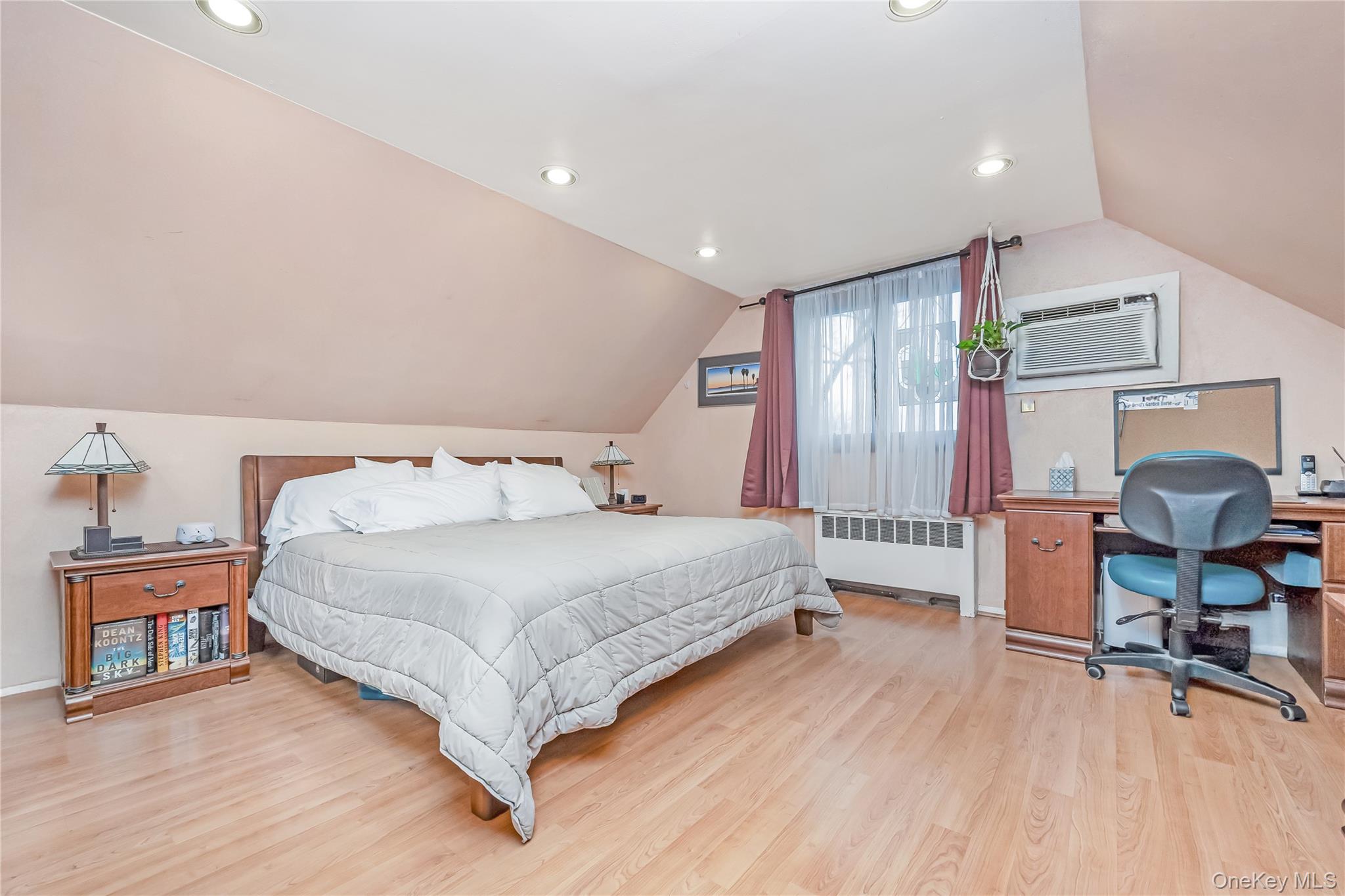 10 Roxbury Street Farmingdale, NY 11735 - Photo 15 of 25 a spacious bedroom with a bed and wooden floor