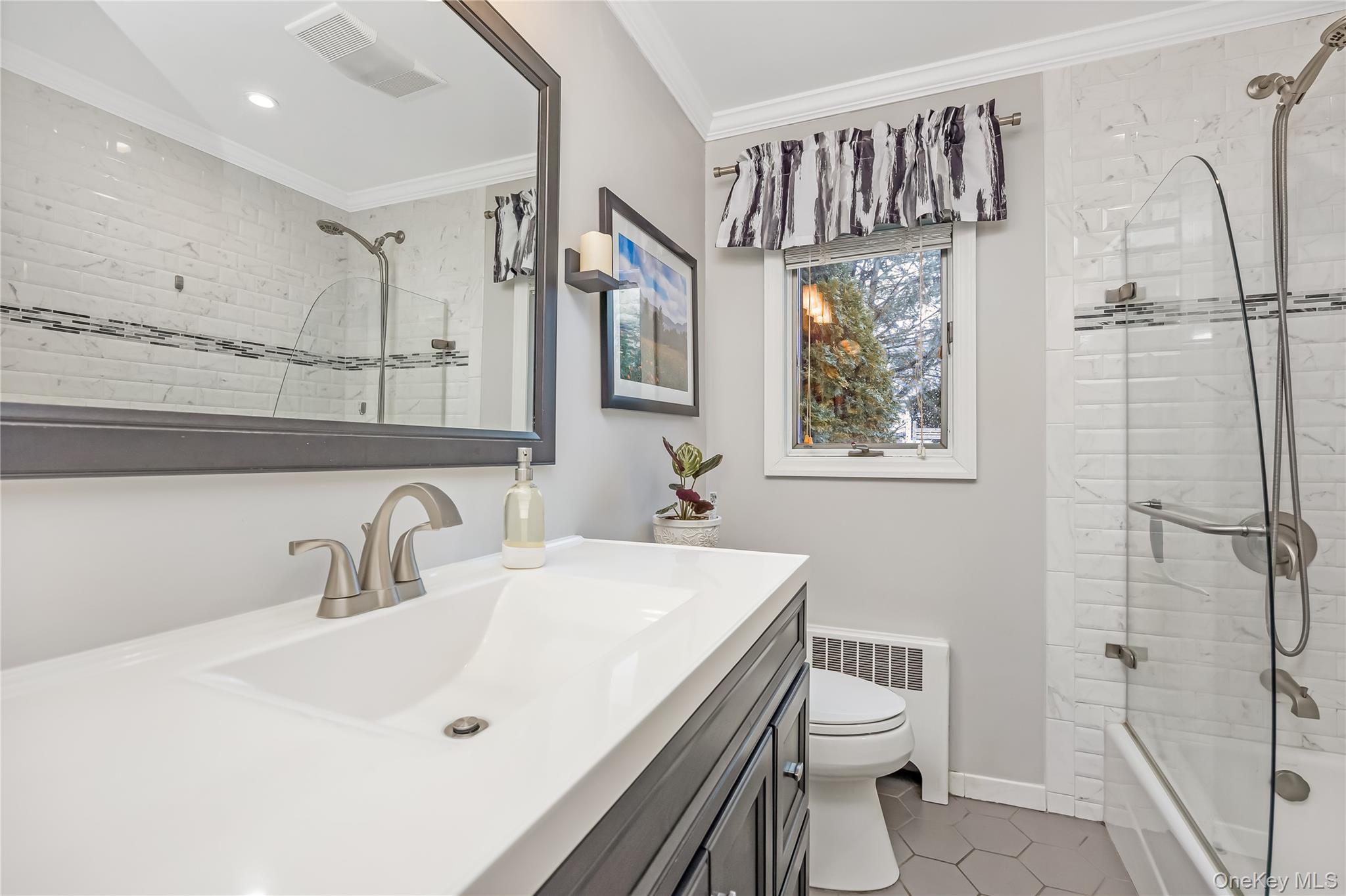 10 Roxbury Street Farmingdale, NY 11735 - Photo 17 of 25 a bathroom with a sink a toilet and shower