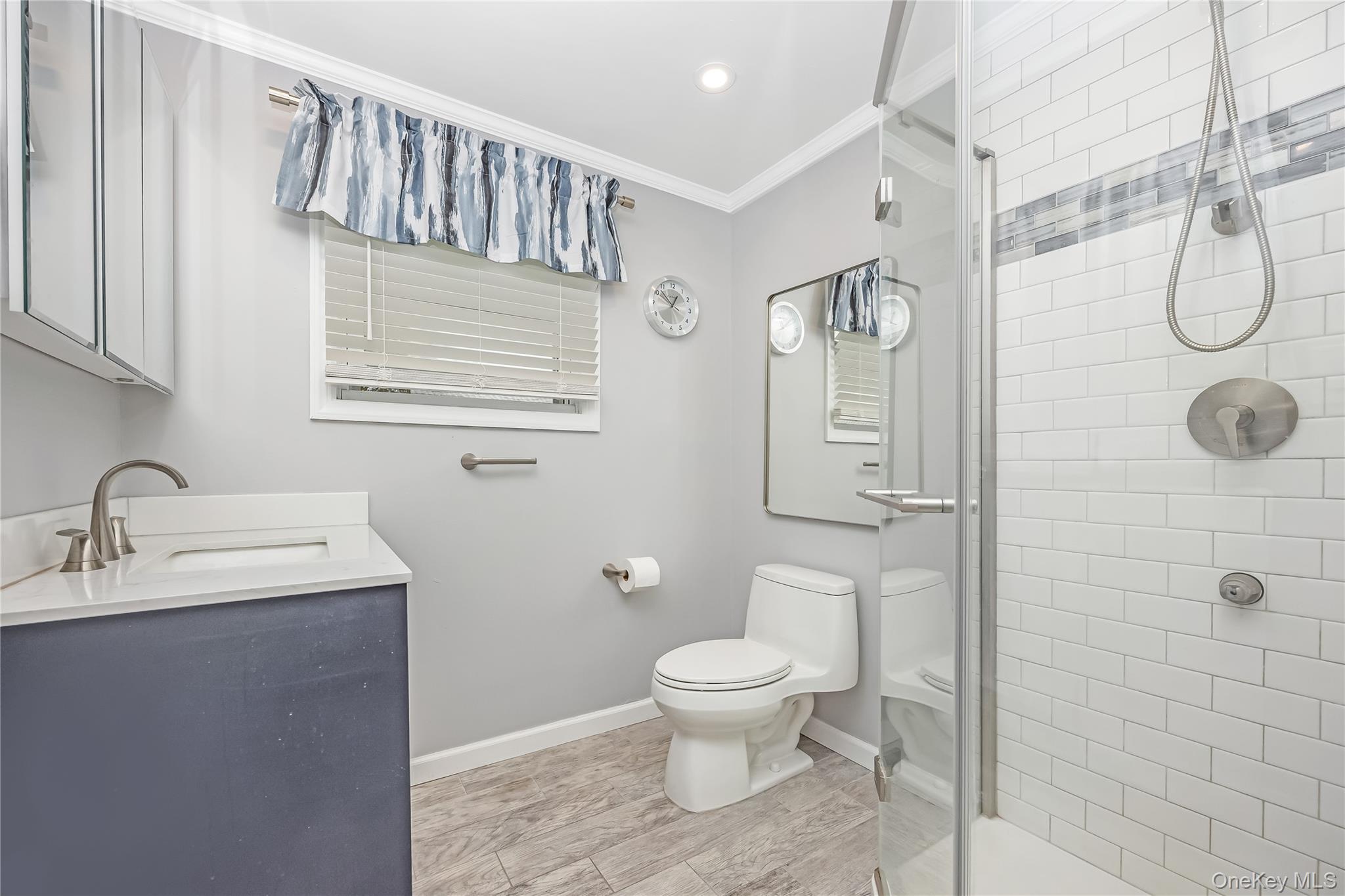 10 Roxbury Street Farmingdale, NY 11735 - Photo 18 of 25 a bathroom with a toilet a sink and mirror