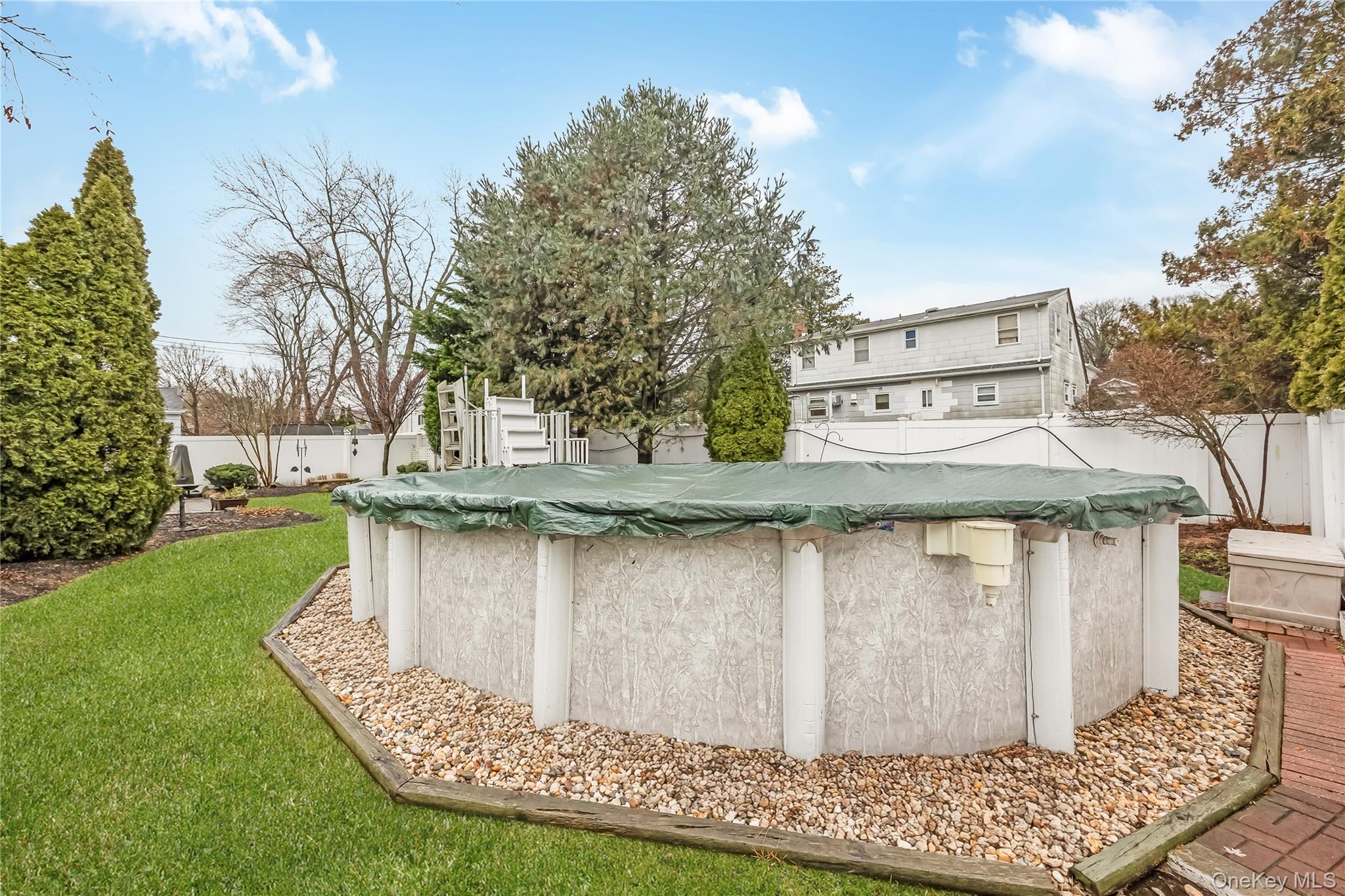 10 Roxbury Street Farmingdale, NY 11735 - Photo 20 of 25 a view of a swimming pool with a patio