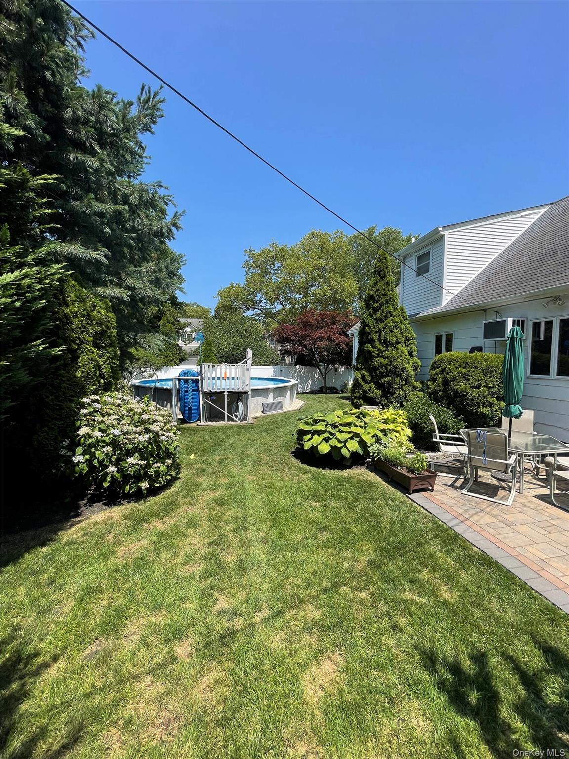 10 Roxbury Street Farmingdale, NY 11735 - Photo 24 of 25 a view of a chair and table in the garden