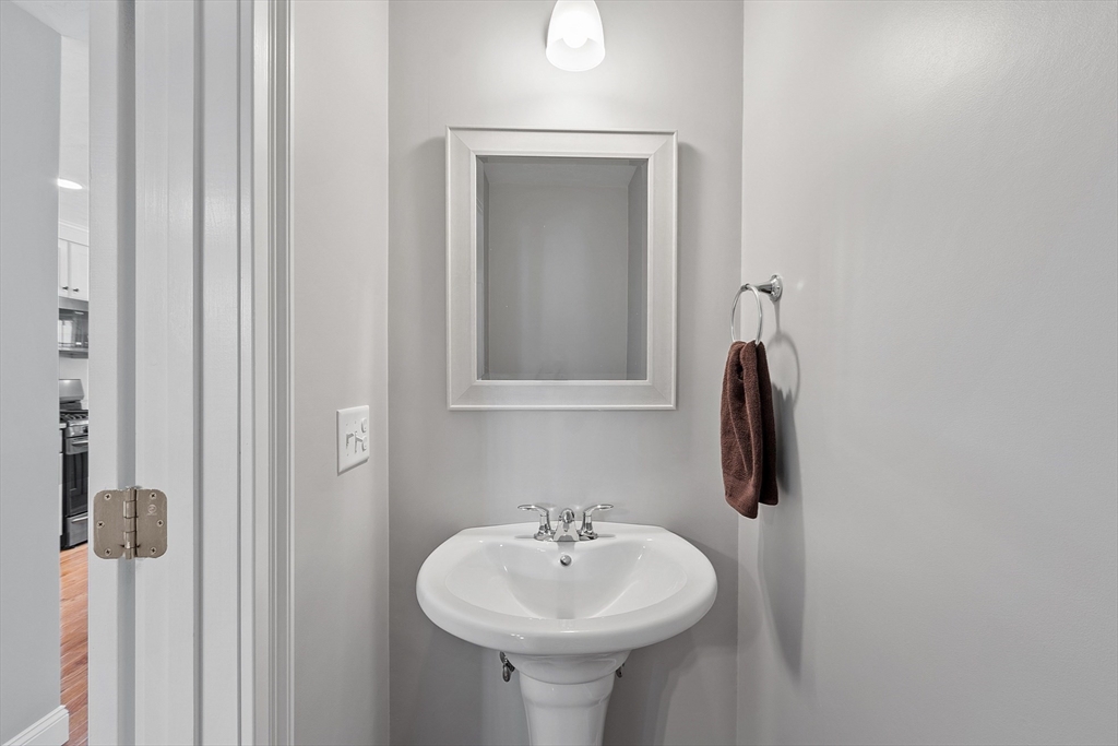4 Scotch Pine Farm Way, Unit 1 Pepperell, MA 01463 - Photo 20 of 35 a bathroom with a sink and a mirror