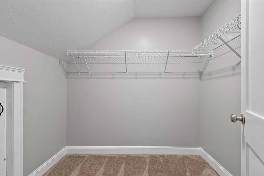 4 Scotch Pine Farm Way, Unit 1 Pepperell, MA 01463 - Photo 26 of 35 a view of a room with racks on the wall