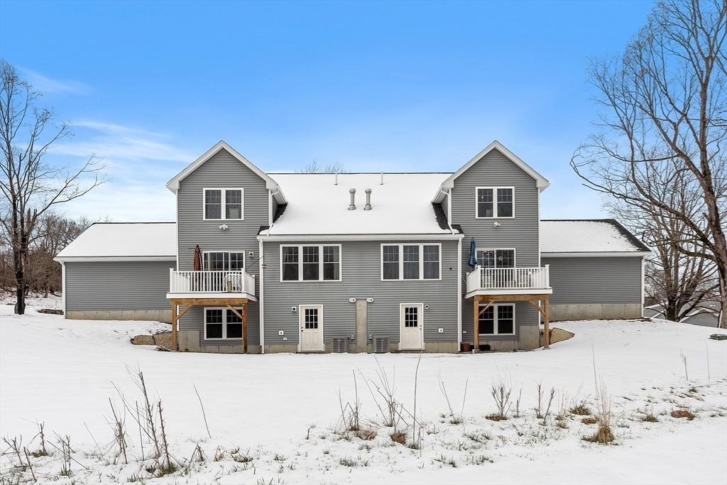 4 Scotch Pine Farm Way, Unit 1 Pepperell, MA 01463 - Photo 30 of 35 a view of a house with a yard covered in snow