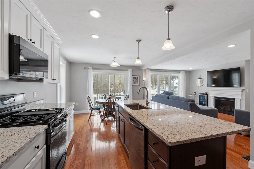 4 Scotch Pine Farm Way, Unit 1 Pepperell, MA 01463 - Photo 7 of 35 a kitchen with granite countertop counter space a sink appliances and cabinets
