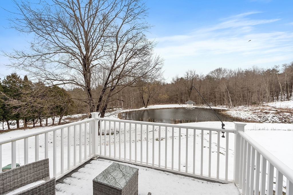 4 Scotch Pine Farm Way, Unit 1 Pepperell, MA 01463 - Photo 9 of 35 a view of a balcony with wooden fence