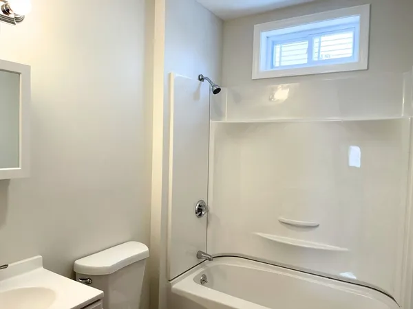 a bathroom with a toilet and a tub