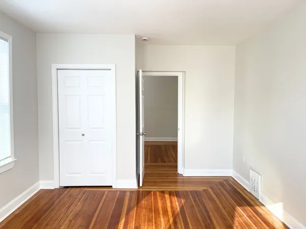 a view of a room with wooden floor and a sink