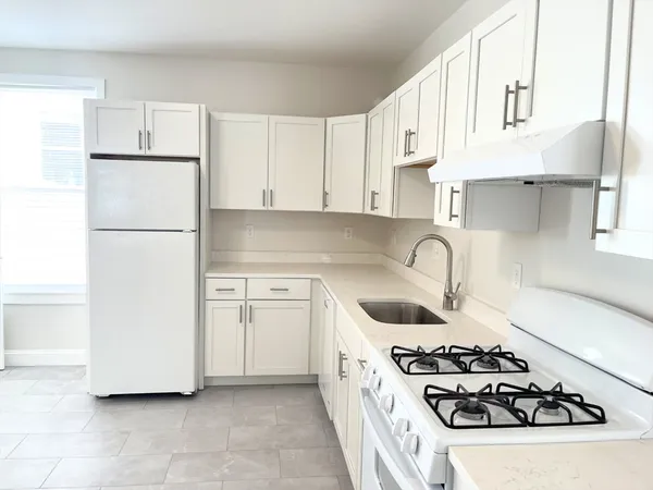 a kitchen with a sink a stove and refrigerator