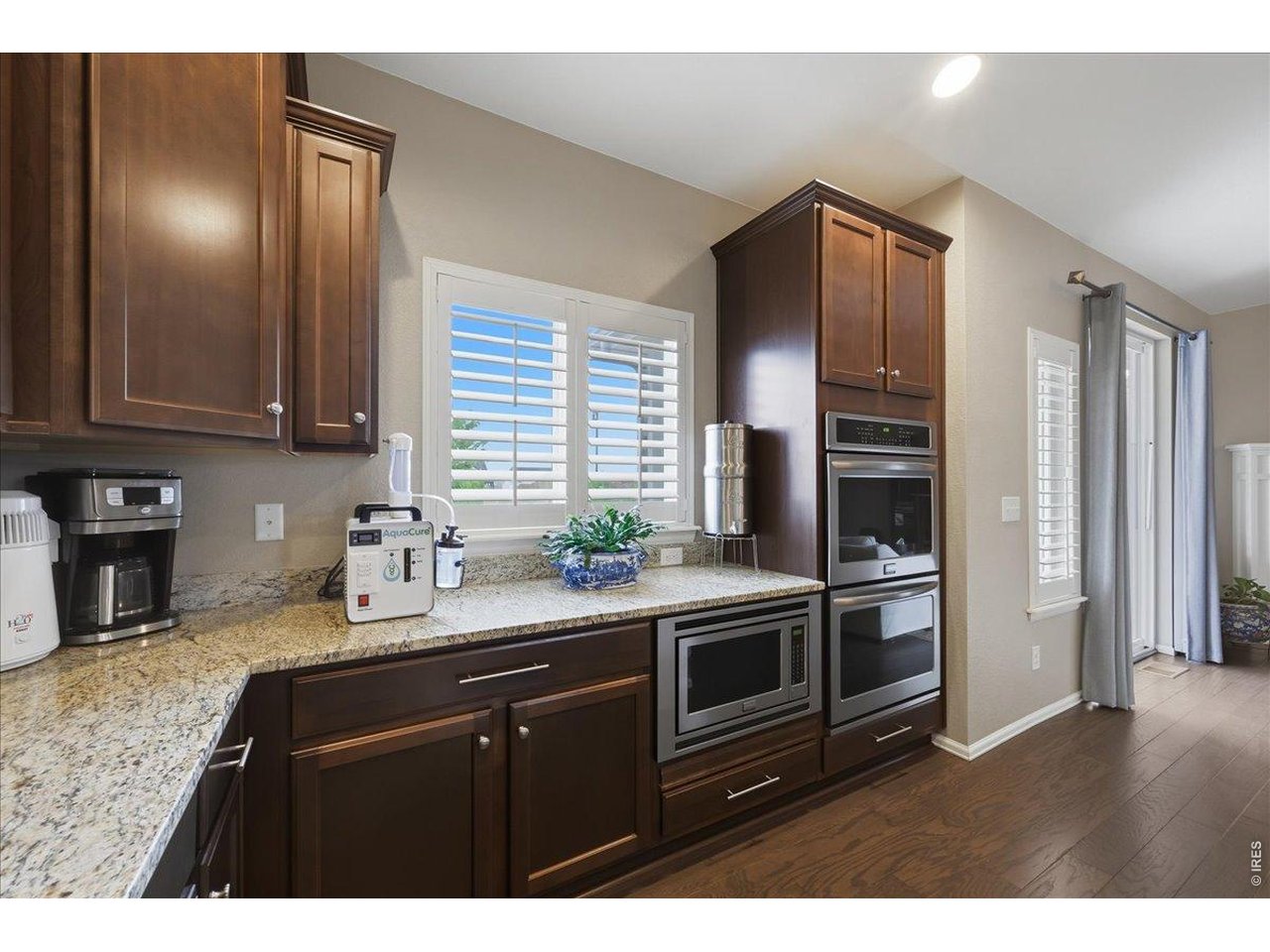 6096 Story Road Timnath, CO 80547 - Photo 14 of 50 a kitchen with stainless steel appliances granite countertop a sink stove and refrigerator