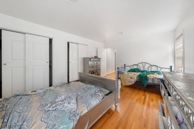 853 Rebecca Place Elizabeth, NJ 07201 - Photo 11 of 22 a bedroom with a bed and a dresser