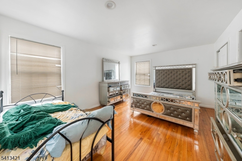 853 Rebecca Place Elizabeth, NJ 07201 - Photo 12 of 22 a bedroom with furniture and a flat screen tv