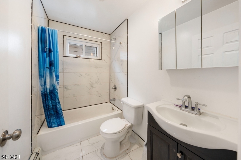 853 Rebecca Place Elizabeth, NJ 07201 - Photo 13 of 22 a bathroom with a sink toilet and shower