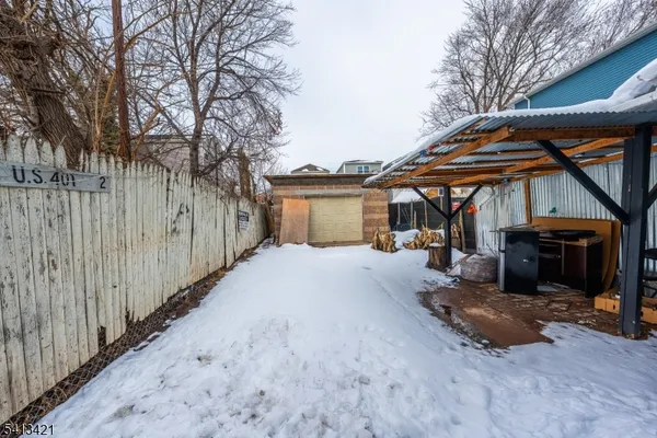 a view of a house with a yard and wooden fence