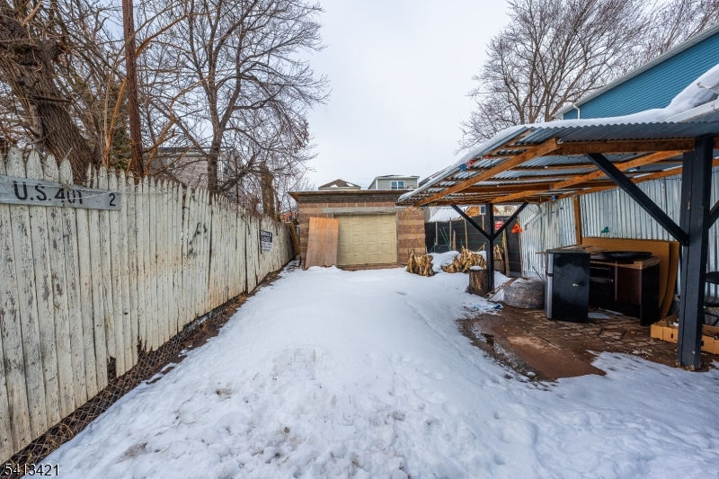 853 Rebecca Place Elizabeth, NJ 07201 - Photo 17 of 22 a view of a house with a yard and wooden fence