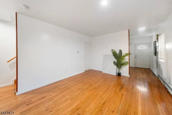 a view of an empty room and wooden floor
