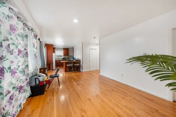a view of a kitchen with workspace and wooden floor