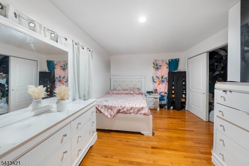 853 Rebecca Place Elizabeth, NJ 07201 - Photo 10 of 22 a spacious bedroom with a bed and a large mirror on the dresser