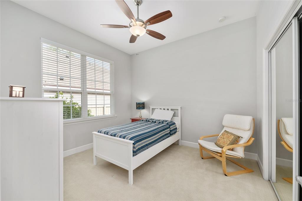 8942 Southwest 25 Road Gainesville, FL 32608 - Photo 14 of 22 a bed room with a bed and a chair