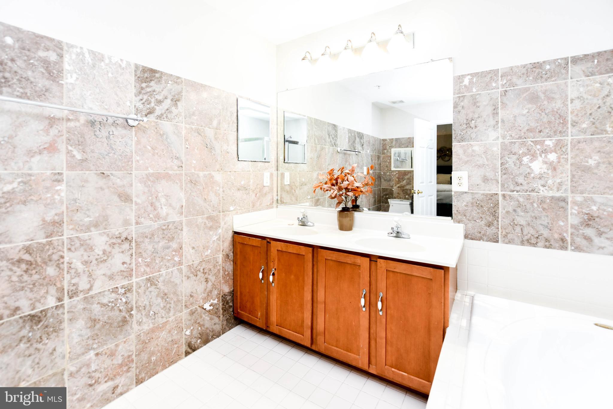 1112 Ryon Way District Heights, MD 20747 - Photo 28 of 63 a bathroom with a sink double vanity and a mirror
