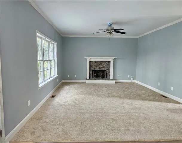 a room with a chair and white walls