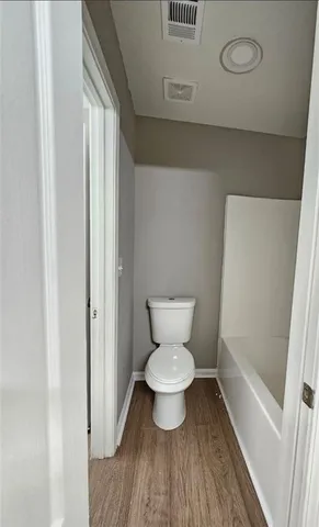 a spacious bathroom with a granite countertop tub sink and mirror