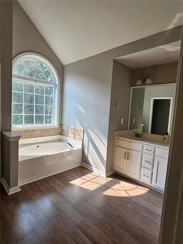 a view of a big room with a ceiling fan