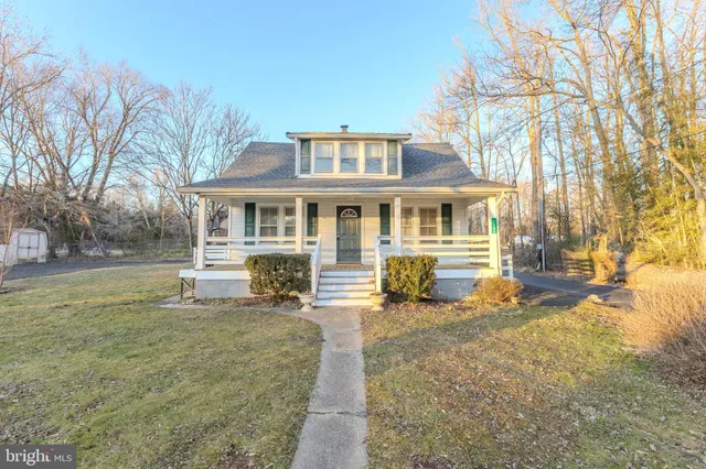 a front view of a house with a yard table and chairs