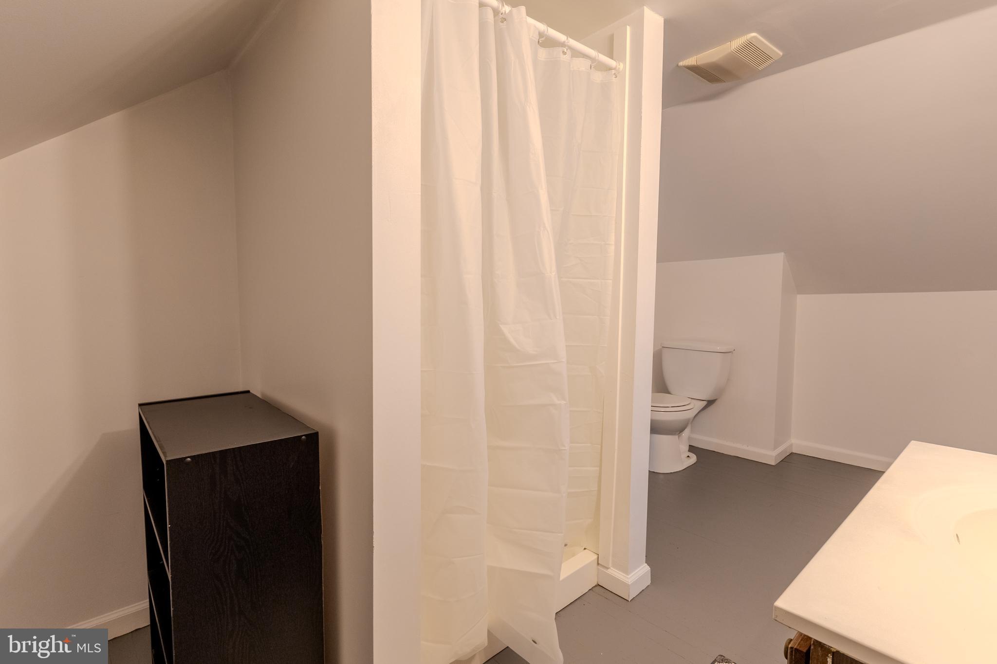 1168 Mt Zion Marlboro Road Lothian, MD 20711 - Photo 24 of 26 a bathroom with a toilet and a shower curtain