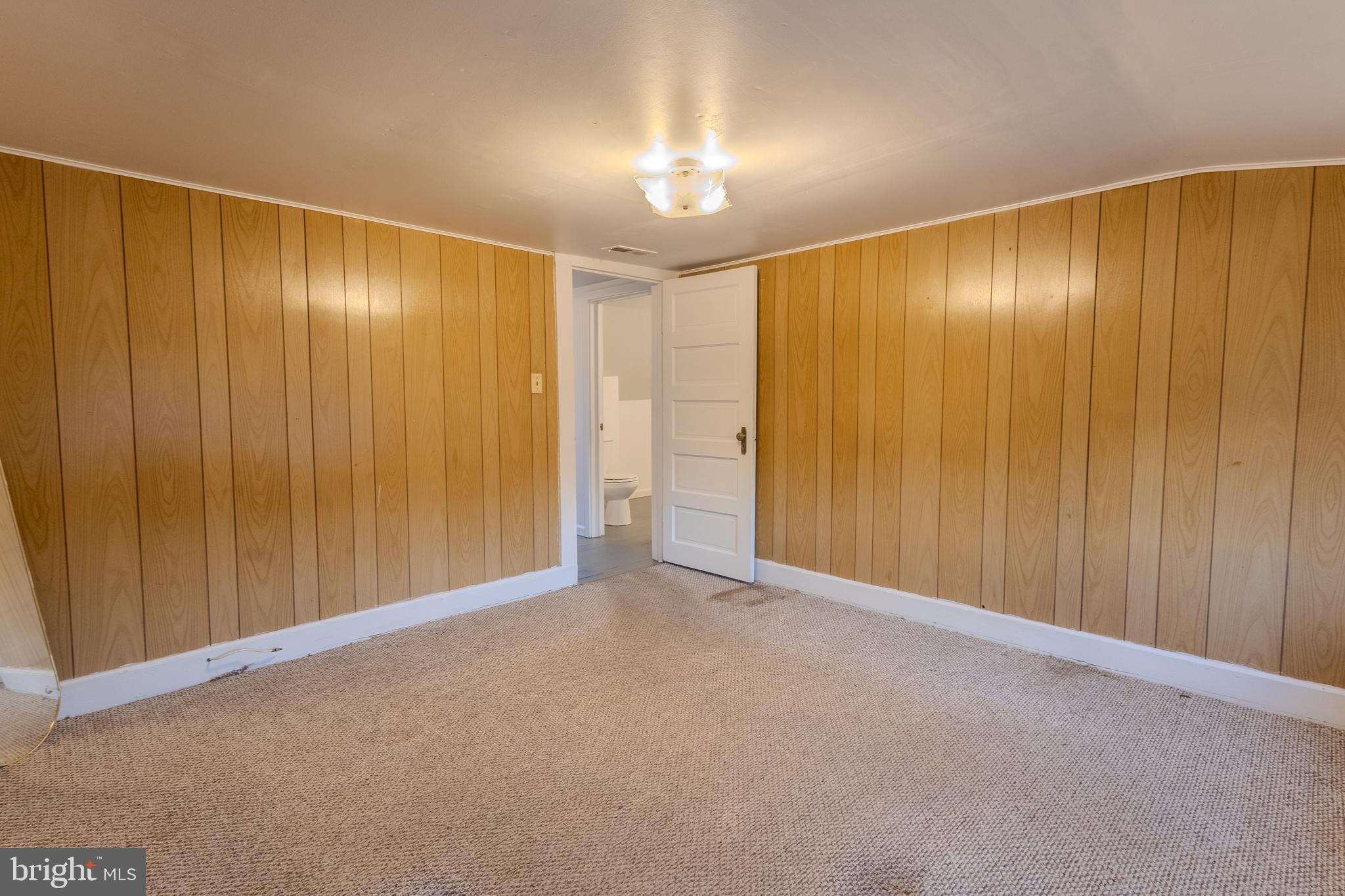 1168 Mt Zion Marlboro Road Lothian, MD 20711 - Photo 26 of 26 a view of an empty room with a wooden door