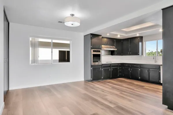 a kitchen with stainless steel appliances granite countertop a stove a sink and a refrigerator