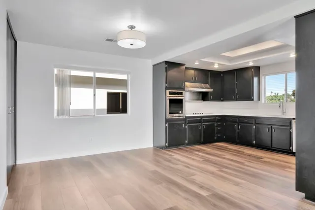 a kitchen with stainless steel appliances granite countertop a stove a sink and a refrigerator