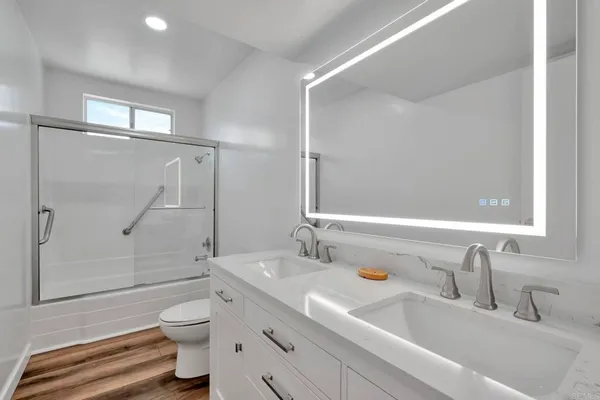 a bathroom with a sink toilet and shower