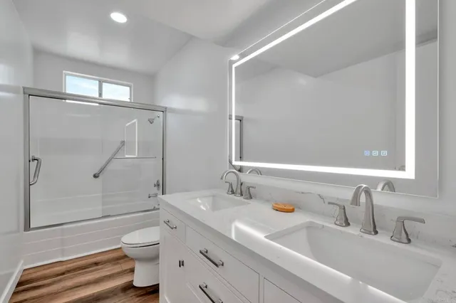 a bathroom with a sink toilet and shower